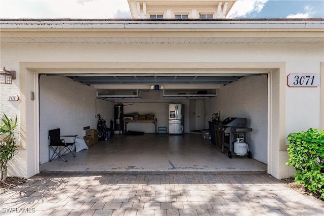 garage with stainless steel fridge with ice dispenser