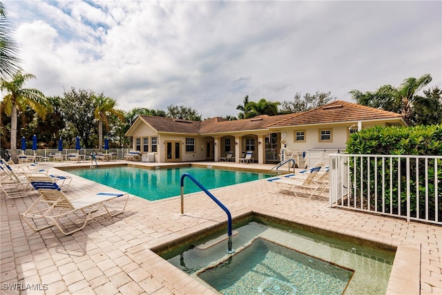 view of pool featuring a hot tub and a patio