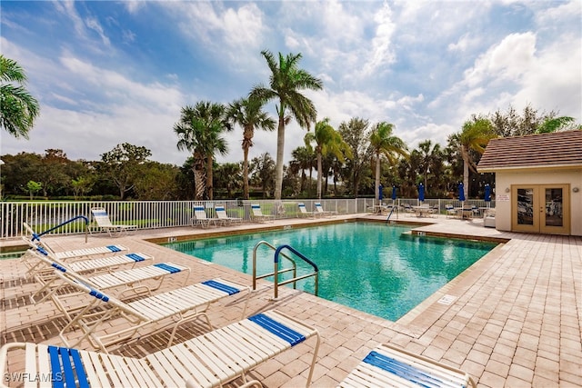 view of pool with a patio area and french doors