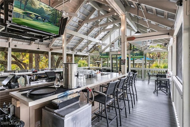 wooden terrace with ceiling fan, a gazebo, and exterior bar