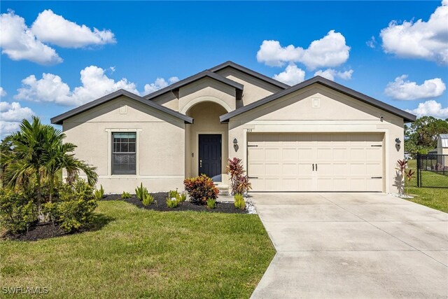 view of front facade featuring a front yard and a garage