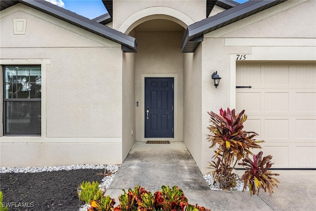 view of exterior entry featuring a garage