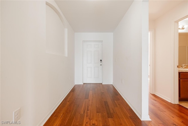 hallway with wood-type flooring