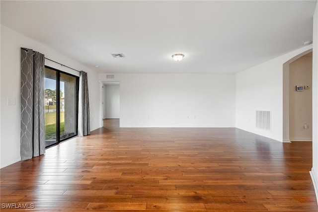 unfurnished room with hardwood / wood-style flooring