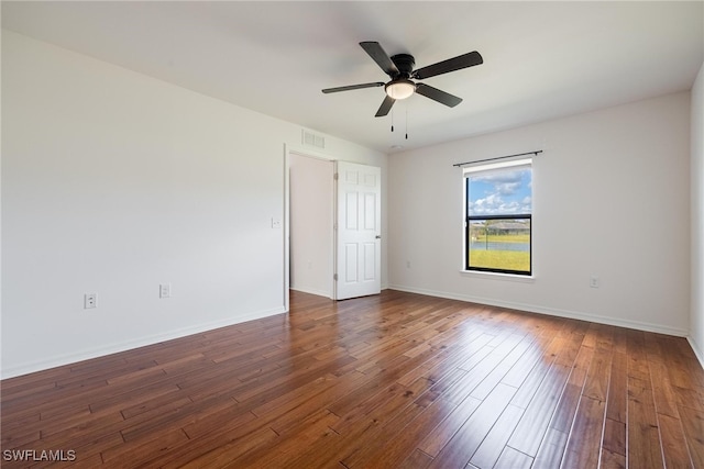 spare room featuring ceiling fan and dark hardwood / wood-style flooring