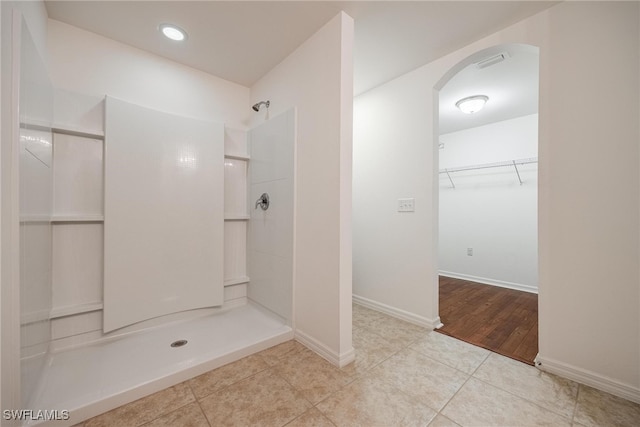 bathroom featuring a shower and tile patterned floors