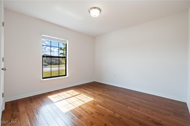 spare room featuring wood-type flooring