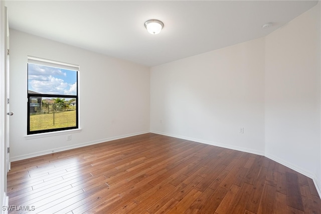 spare room with wood-type flooring