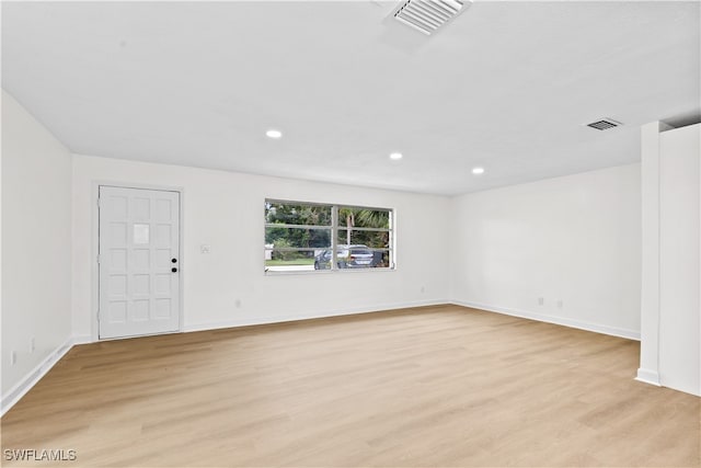 spare room featuring light hardwood / wood-style flooring