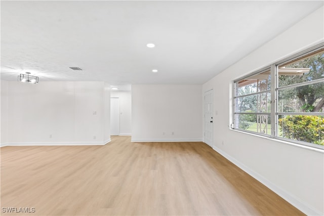 spare room featuring light hardwood / wood-style flooring