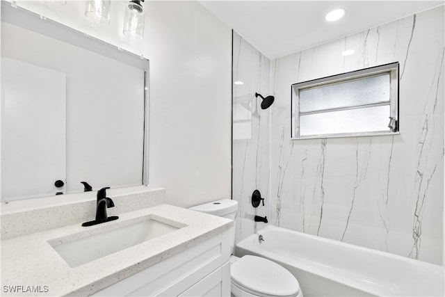 full bathroom featuring vanity, tiled shower / bath combo, and toilet