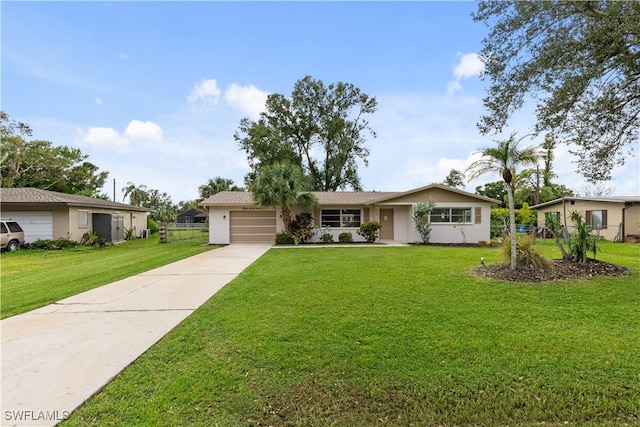 single story home featuring a garage and a front lawn