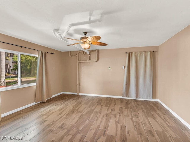 unfurnished room featuring ceiling fan and light hardwood / wood-style floors