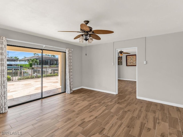 spare room with hardwood / wood-style floors and ceiling fan