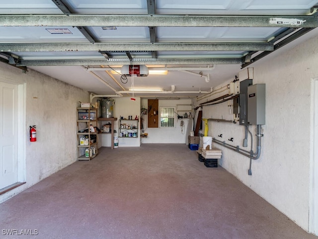 garage featuring electric water heater and a garage door opener