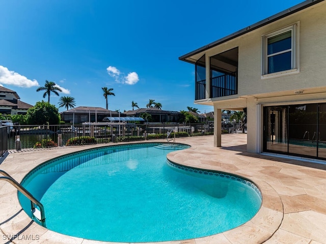 view of swimming pool featuring a patio area