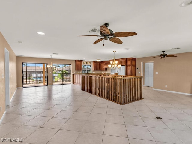 interior space with ceiling fan with notable chandelier and light tile patterned floors