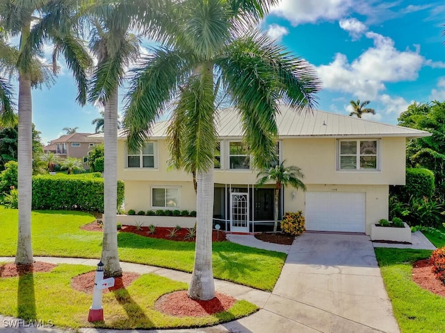 view of front of house featuring a front yard and a garage