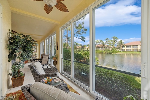 sunroom / solarium with lofted ceiling with beams, ceiling fan, a water view, and plenty of natural light