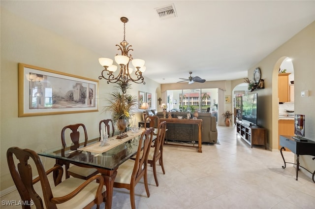 dining area featuring light tile patterned floors and ceiling fan with notable chandelier