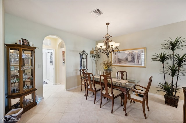 tiled dining area featuring a notable chandelier