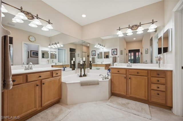 bathroom featuring vanity, tile patterned floors, and a bathtub