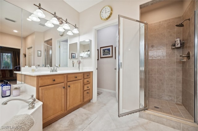 bathroom featuring vanity, walk in shower, and tile patterned flooring