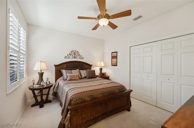 bedroom featuring light carpet, a closet, and ceiling fan