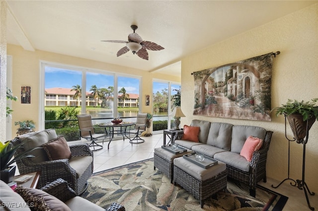 sunroom with a water view and ceiling fan