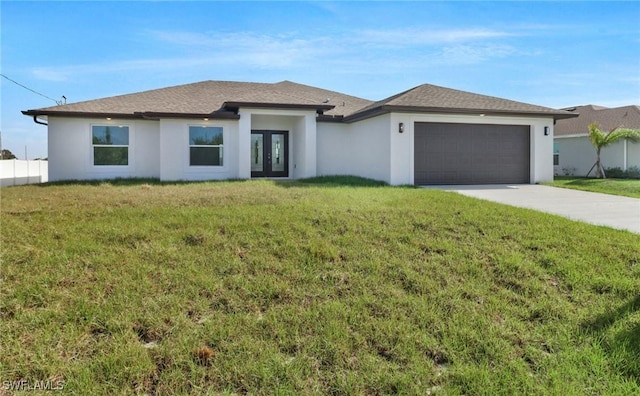 381 Paulcrest Ave, Lehigh Acres, FL 33974 - prairie-style home with french doors, driveway, an attached garage, and a front lawn