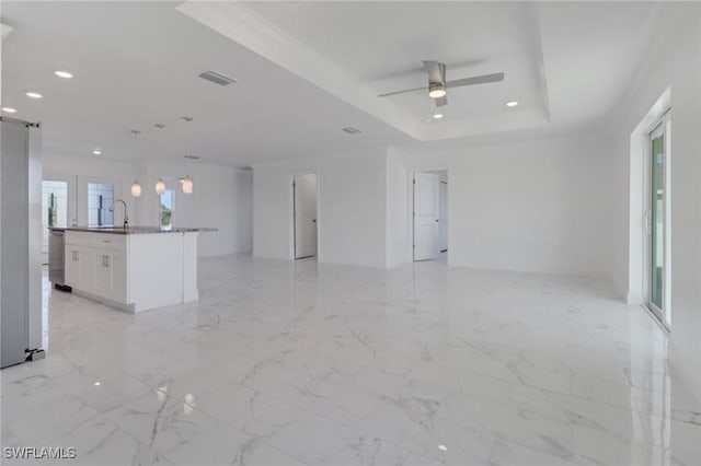 381 Paulcrest Ave, Lehigh Acres, FL 33974 - unfurnished living room featuring a tray ceiling, recessed lighting, a sink, a ceiling fan, and light marble finish floors
