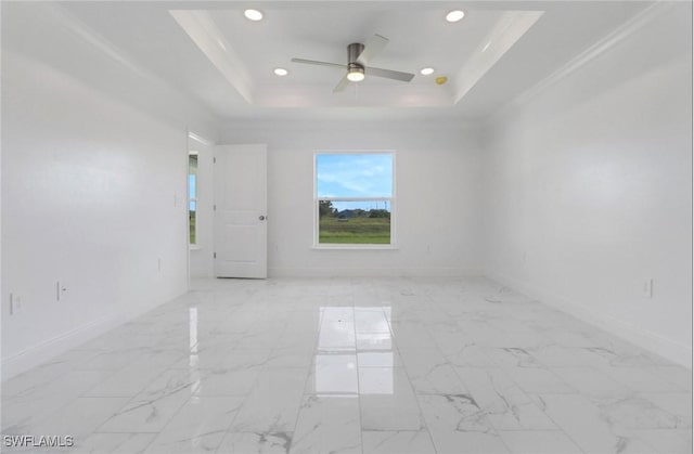 381 Paulcrest Ave, Lehigh Acres, FL 33974 - unfurnished room with a tray ceiling, a ceiling fan, baseboards, recessed lighting, and light marble finish floors