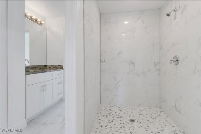 bathroom featuring vanity and tiled shower