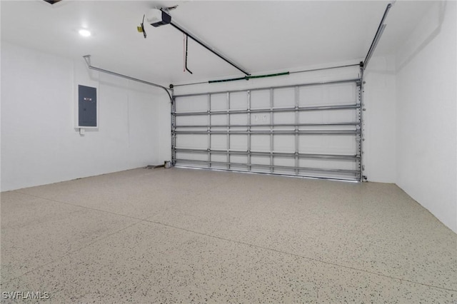 381 Paulcrest Ave, Lehigh Acres, FL 33974 - garage with electric panel and a garage door opener