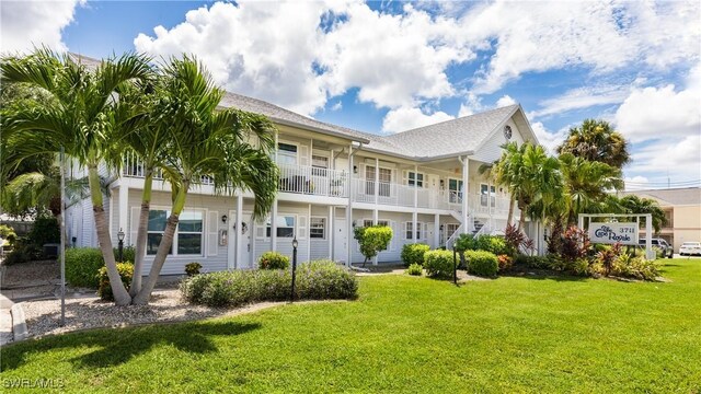 exterior space with a front yard and a balcony