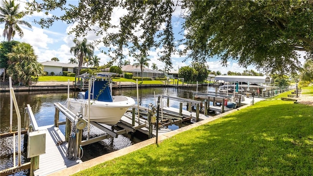 view of dock featuring a lawn and a water view