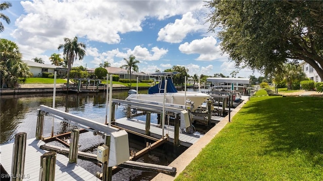 dock area with a yard, a water view, and boat lift