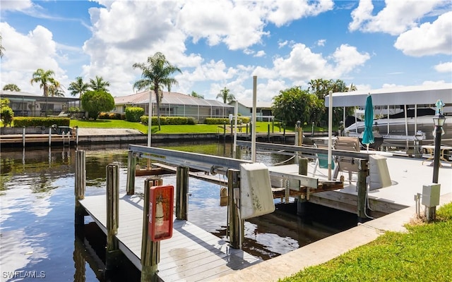 dock area with a water view and boat lift