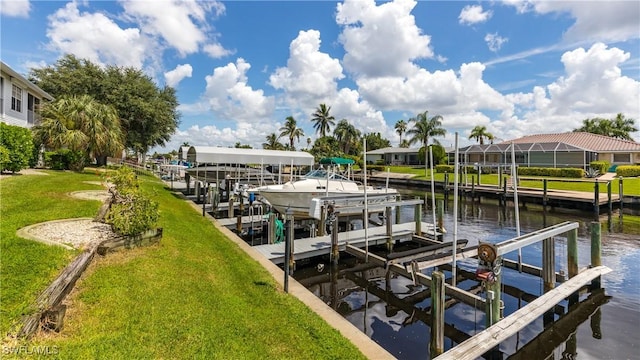 view of dock featuring a lawn, a water view, and boat lift