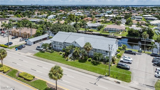 bird's eye view featuring a residential view and a water view