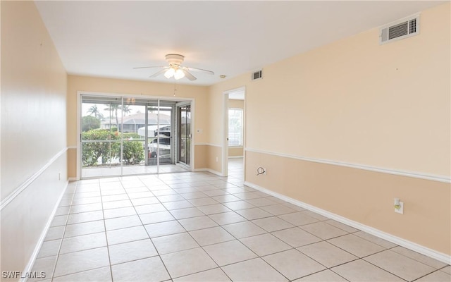 spare room featuring ceiling fan, light tile patterned floors, visible vents, and baseboards