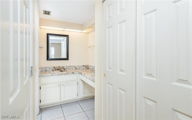 bathroom with visible vents, vanity, and tile patterned floors