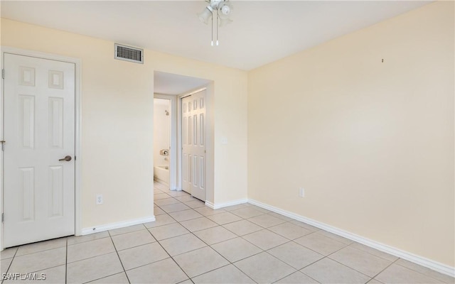 spare room featuring visible vents, baseboards, and light tile patterned floors