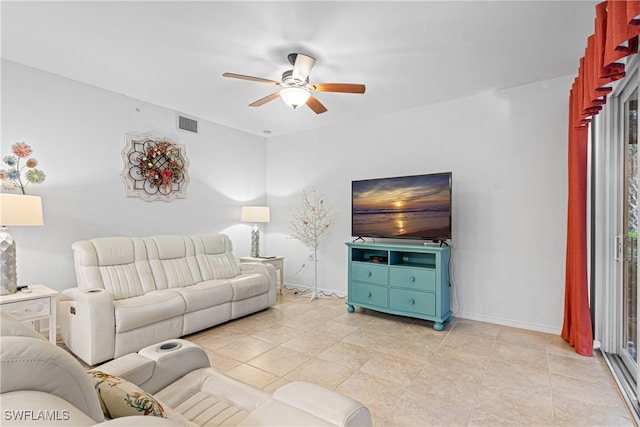 tiled living room with ceiling fan