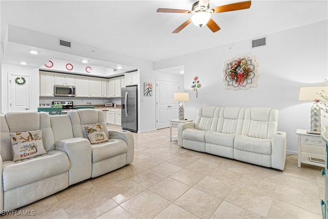 living room with ceiling fan and light tile patterned floors