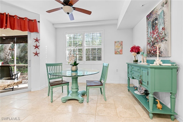 dining space featuring light tile patterned flooring and ceiling fan