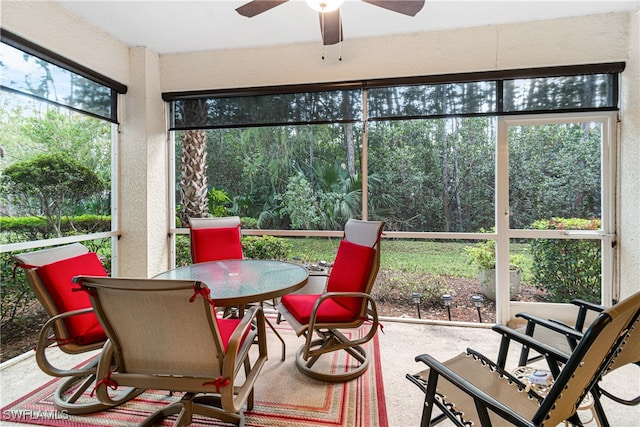 sunroom featuring ceiling fan and plenty of natural light