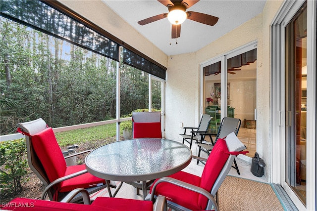 sunroom featuring ceiling fan