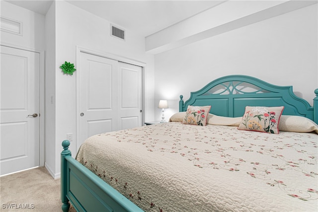 bedroom featuring light carpet and a closet