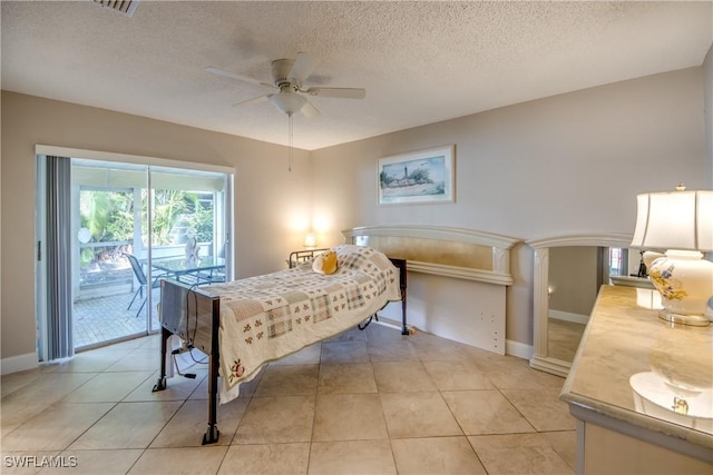 bedroom with ceiling fan, light tile patterned floors, access to exterior, and a textured ceiling